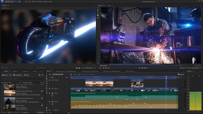 HitFilm Pro 16 mid-edit: a rendered lightbike in the trimmer, a graded shot of a welder in the viewer, and a multi-track timeline of video and audio layers beneath both.
